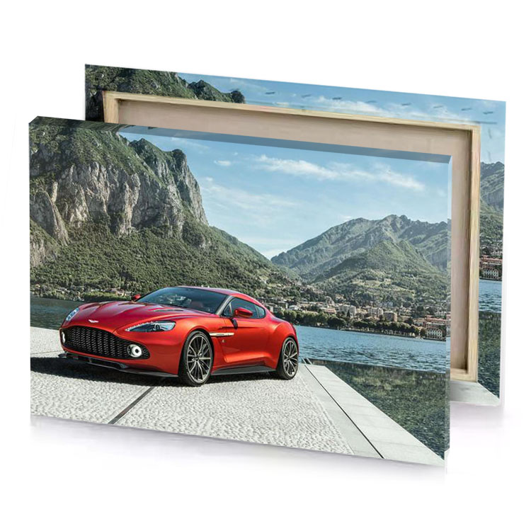 the aston gtr is parked on a dock next to brown canvas