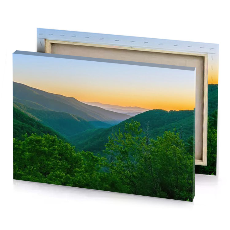 the sun sets over mountains in charcoal canvas