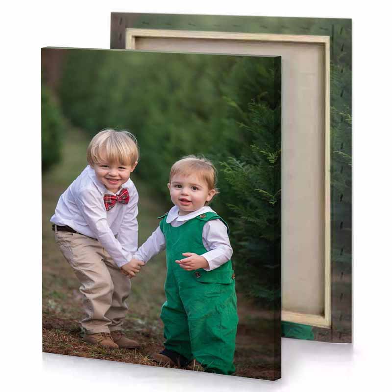 two boys in green overalls and bow ties playing the hunter canvas