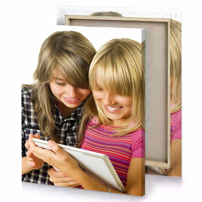 two girls looking at a tablet snow canvas