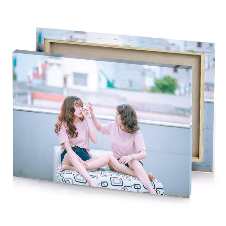 two girls sitting on a couch light steel blue canvas