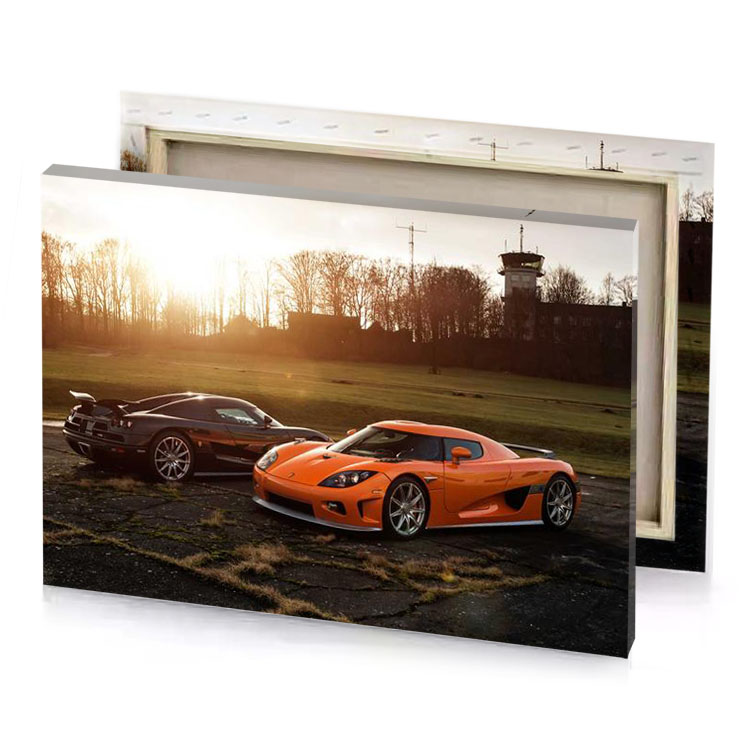 two orange sports cars parked in a parking lot copper canvas