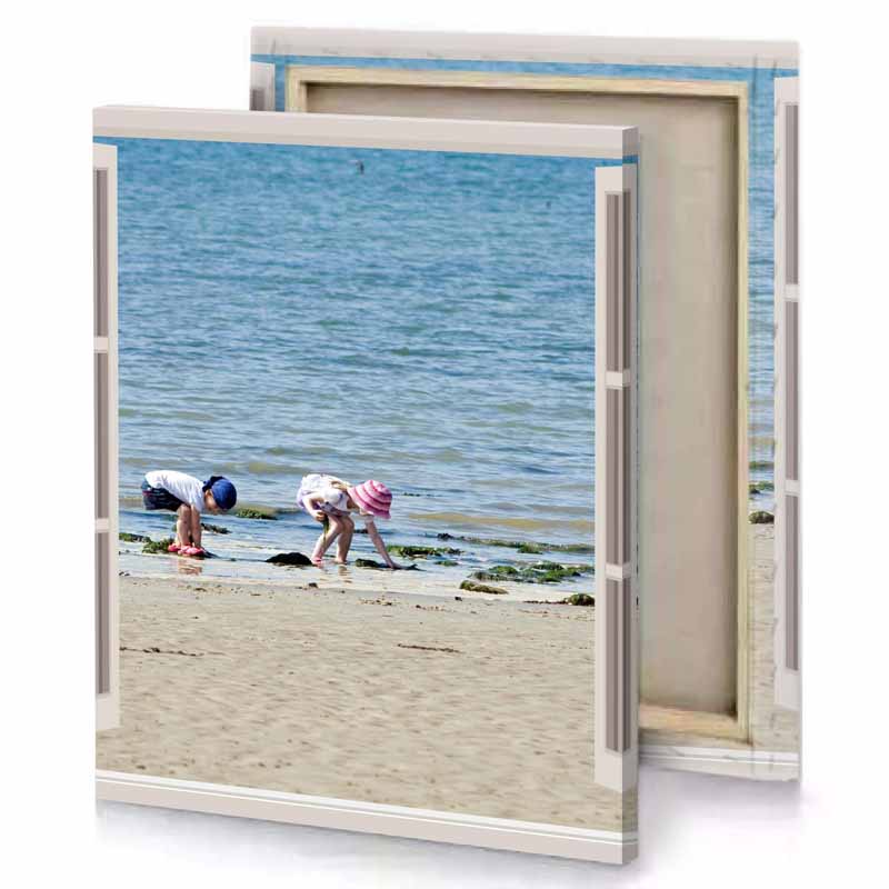 two people are on the beach looking out at water moonstone blue canvas