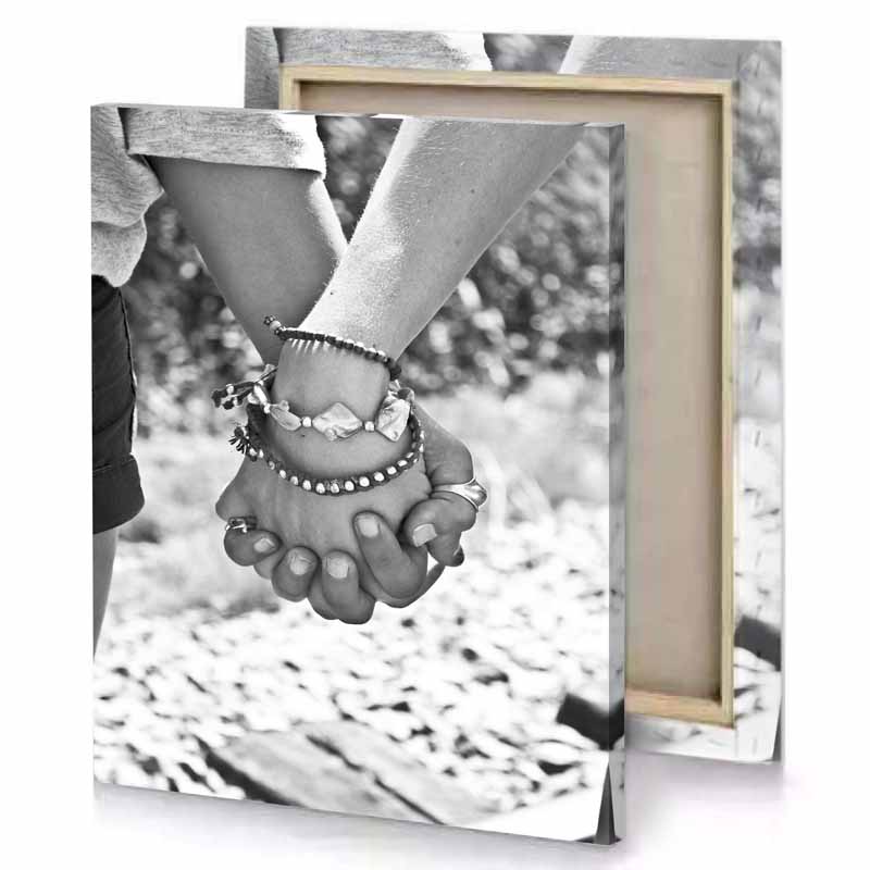 two people holding hands while walking in the woods gray canvas