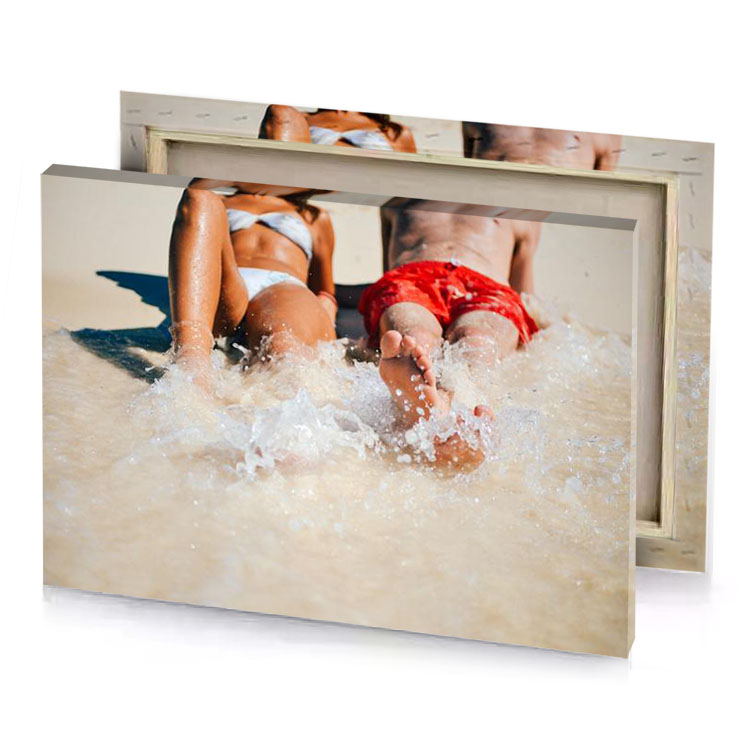 two people laying in the water on a beach gainsboro canvas