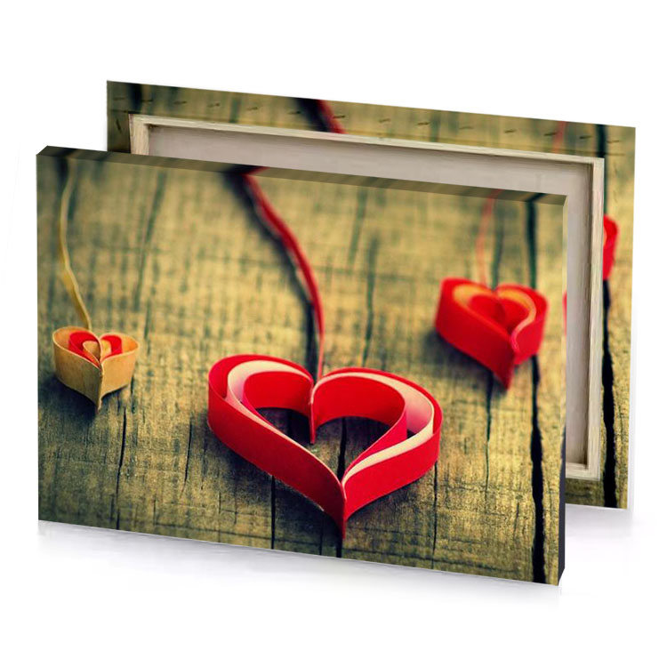 two red hearts on a wooden table spanish canvas