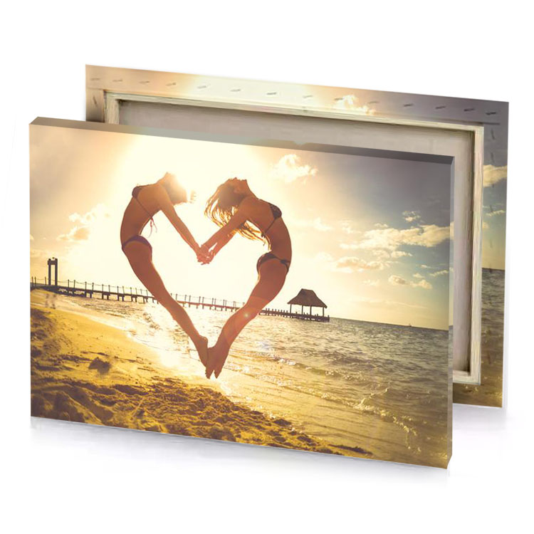 two women making a heart shape on the beach corn silk canvas