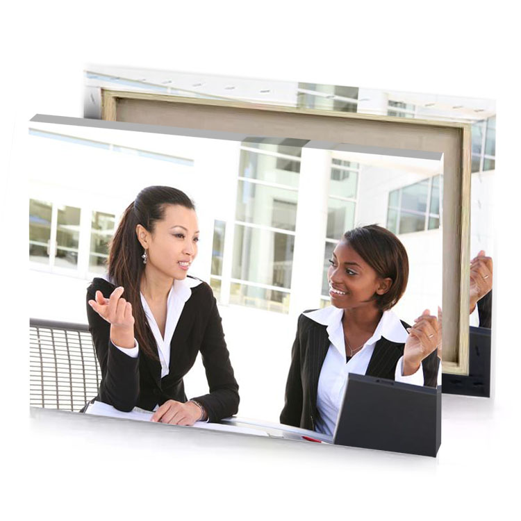 two women sitting at a table with laptops white smoke canvas