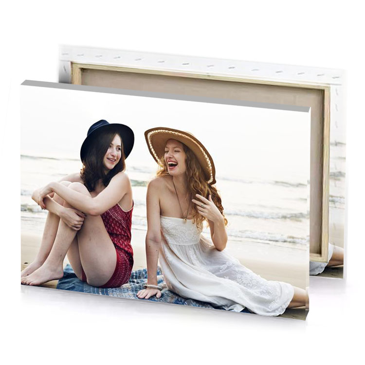 two women sitting on the beach white smoke canvas